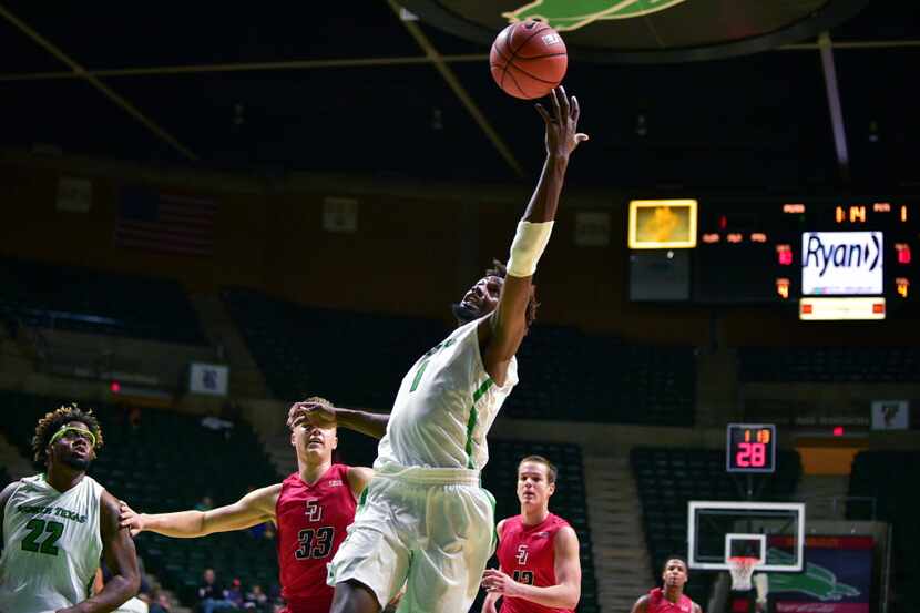 North Texas sophomore forward Jeremy Combs (1) reaches out trying to grab a loose ball...