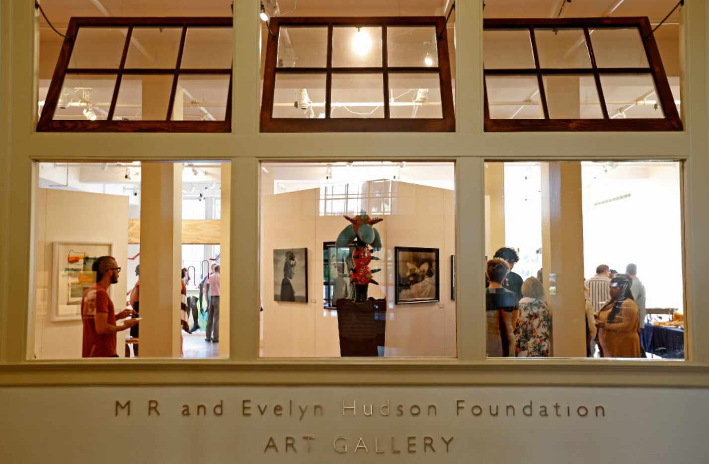People gather during an alumni art exhibit and reception of the Booker T. Washington's 40th...