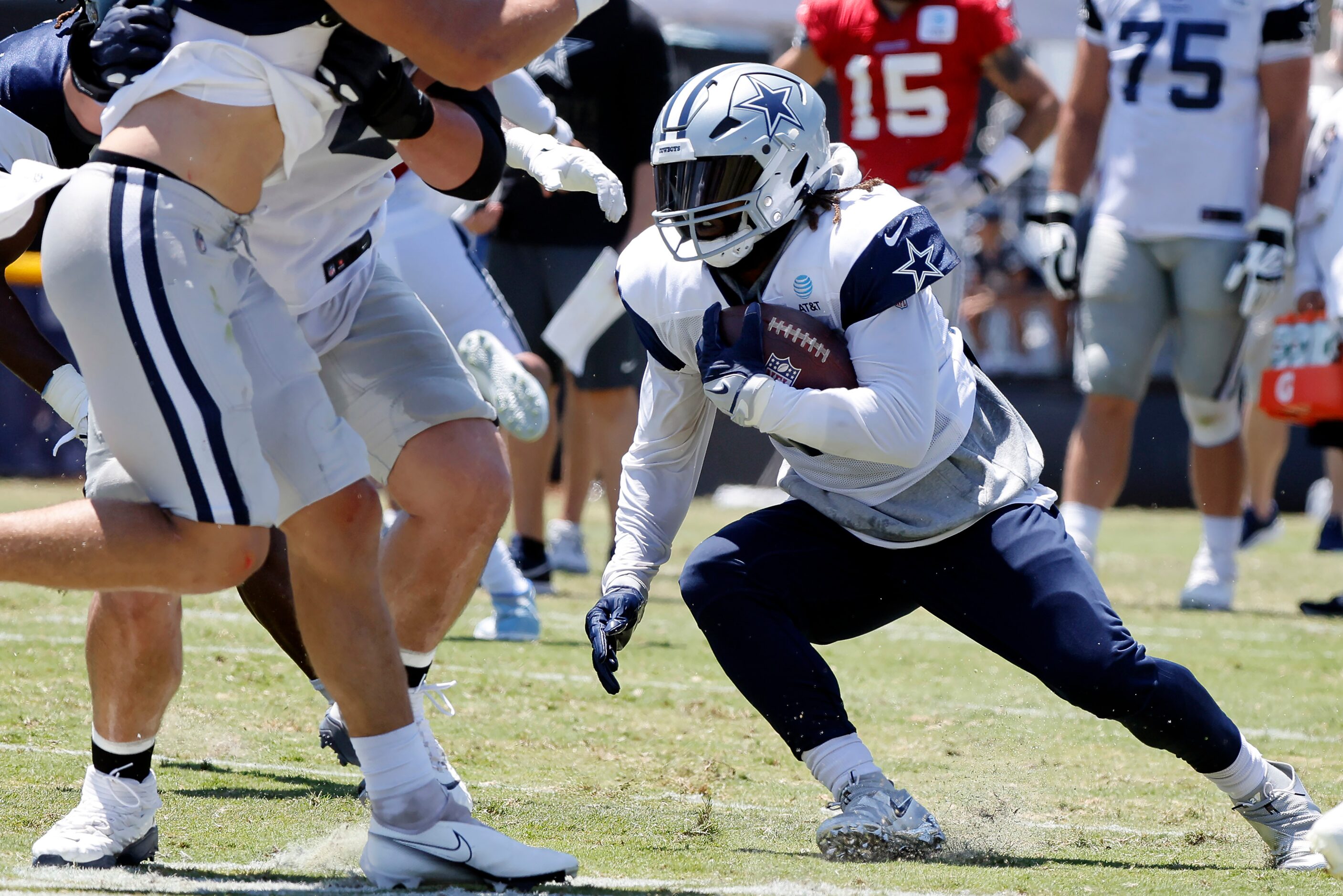 Dallas Cowboys running back Ezekiel Elliott (21) cuts back against the defense during...