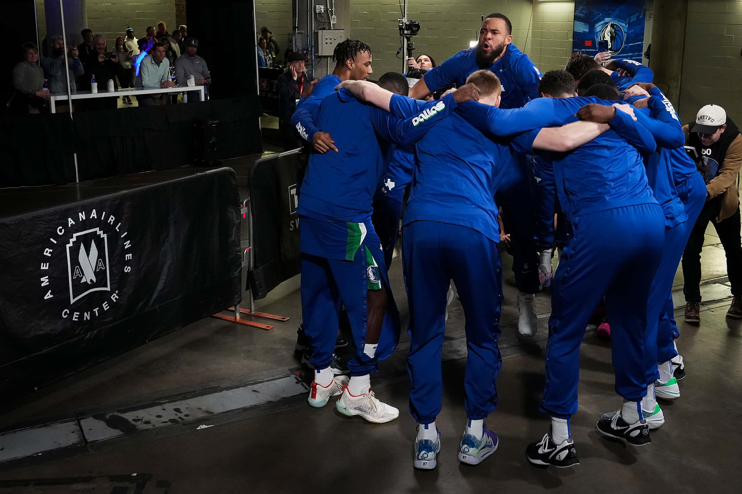 Dallas Mavericks players huddle around center JaVale McGee (00) before the take the court...