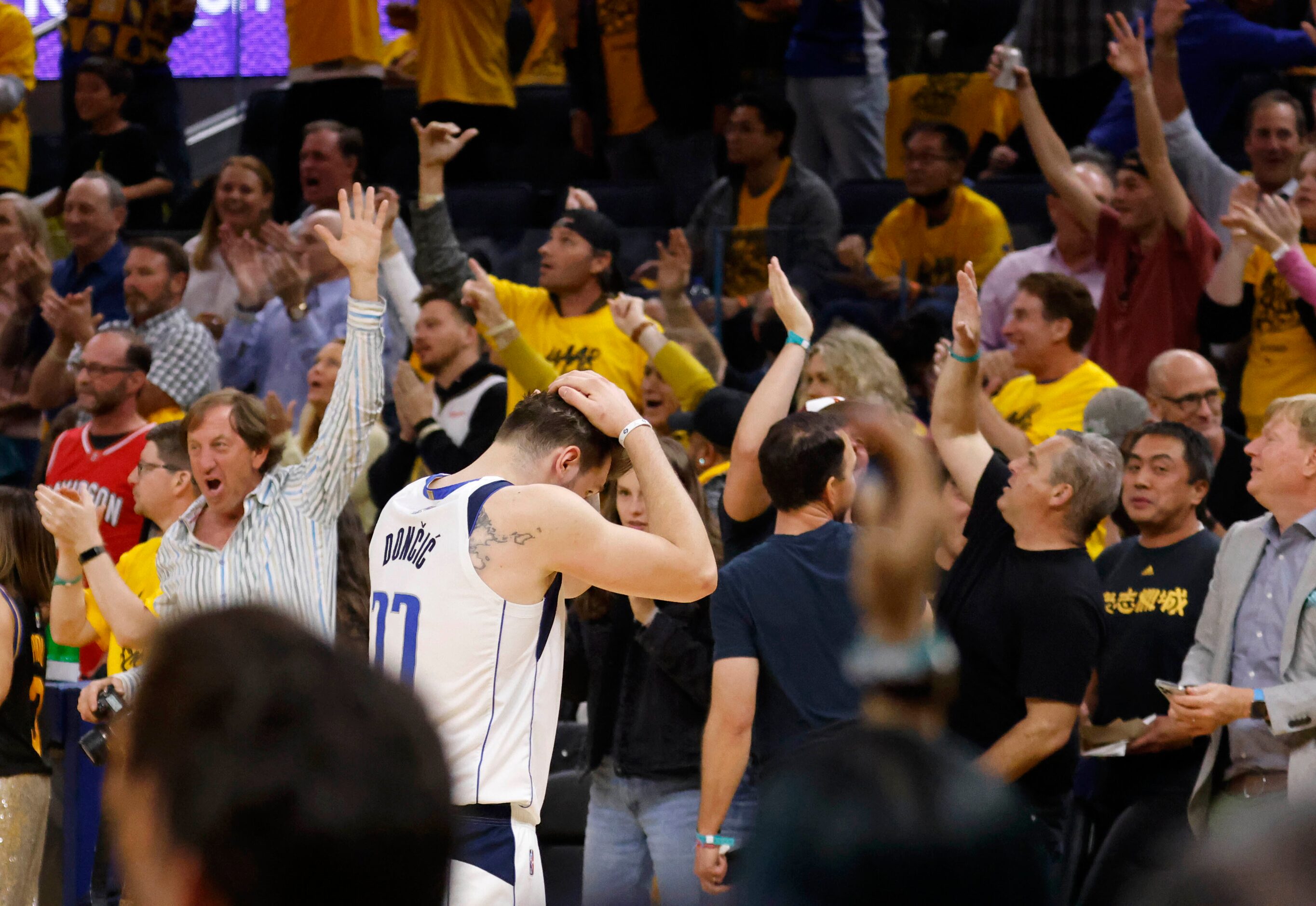 Dallas Mavericks guard Luka Doncic (77) makes his way towards the bench after a timeout was...