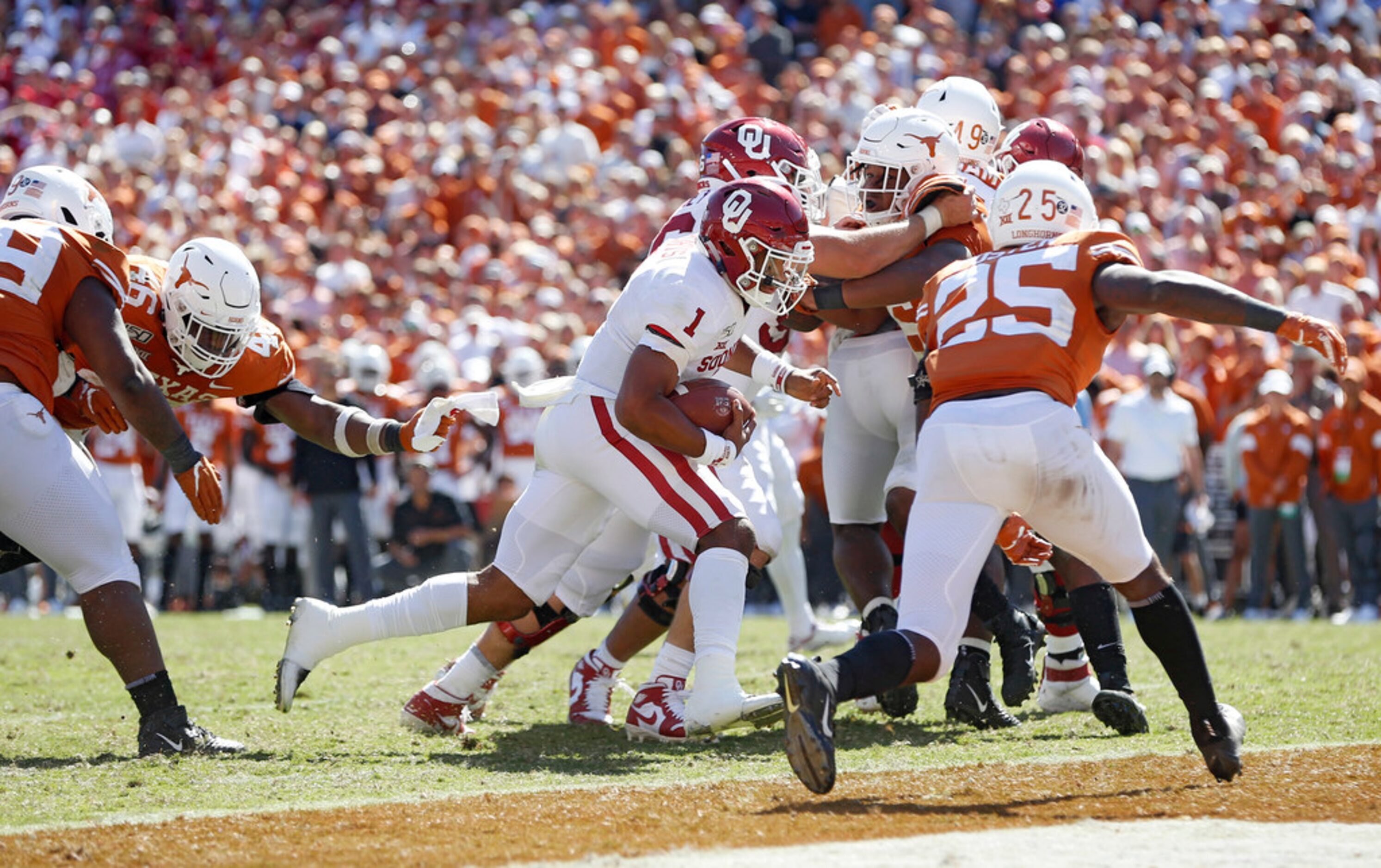 Oklahoma Sooners quarterback Jalen Hurts (1) scores a touchdown as Texas Longhorns defensive...