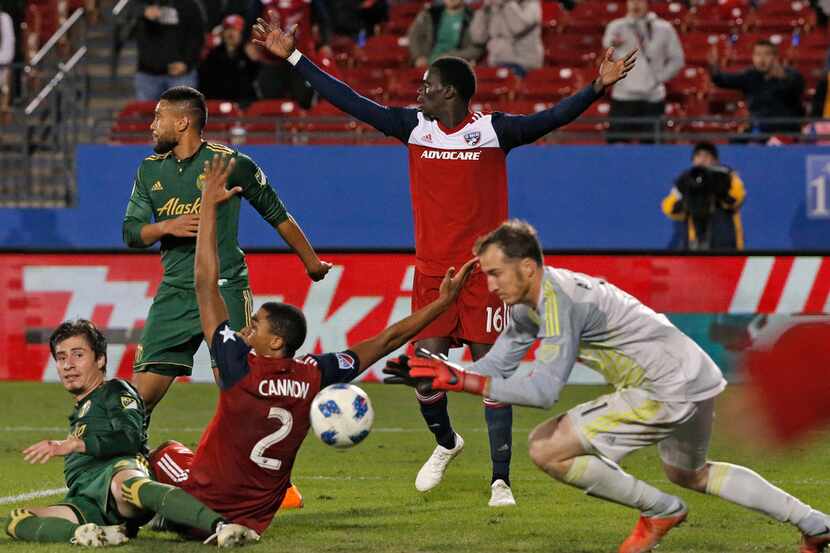 FC Dallas' Reggie Cannon (2) and Dominique Badji (16) look for a call from the officials as...