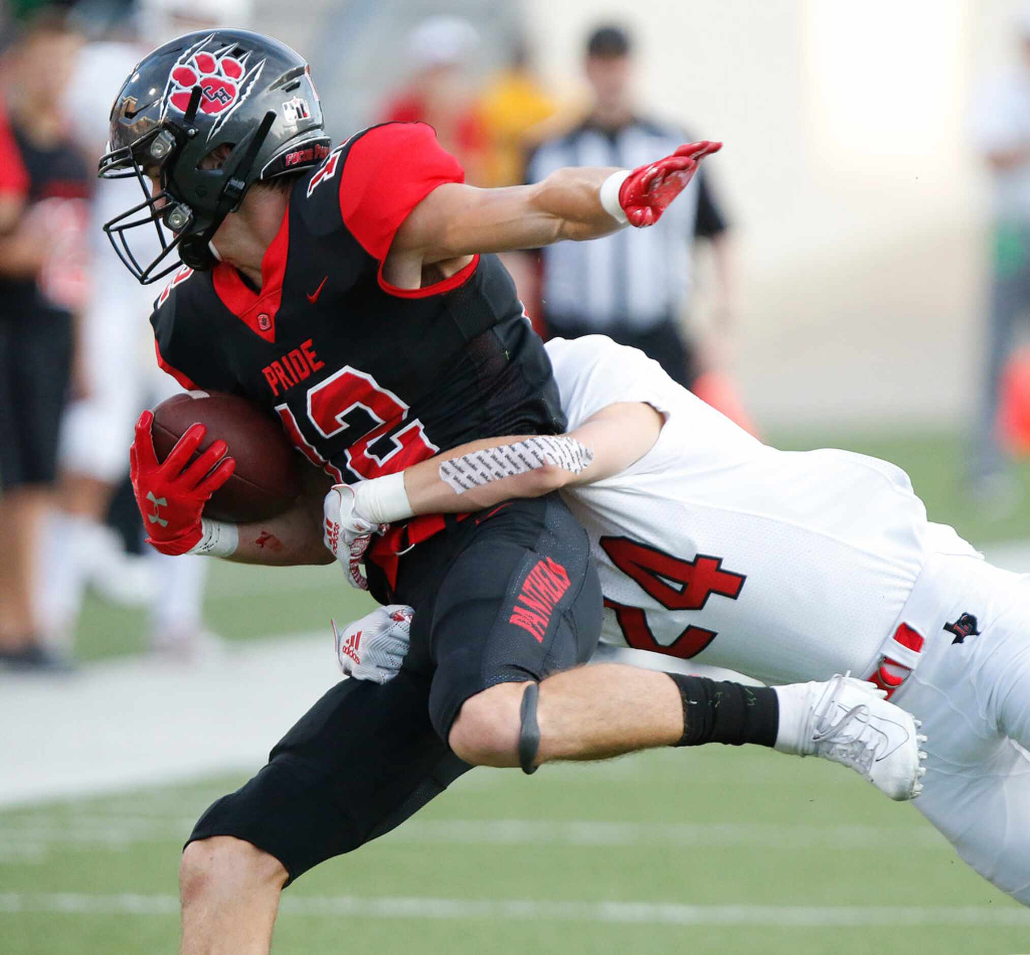 Colleyville Heritage High School quarterback Brayden Gerlich (12) is tackled by Lovejoy High...