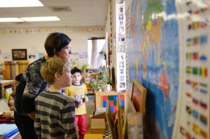 
Montessori teacher Penny Carter helps student Nicolas Metz at The Dallas North Montessori...
