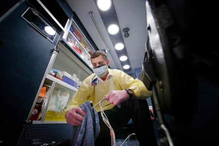 
Kyle Hoagland, an EMT for CareFlite, goes through decontamination techniques for an...