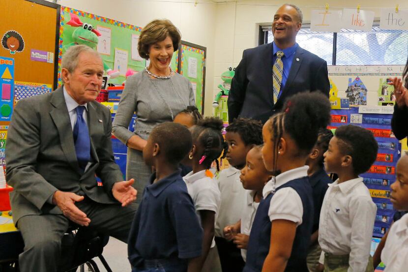 Former President George W. Bush and his wife Laura visit a classroom at Edward J. Briscoe...