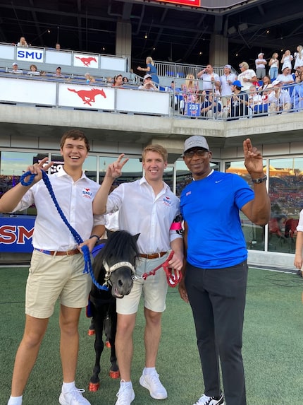 Peruna and her handlers Ryan Bray (far left) and Capt. Adam Handler (middle) pose for a...