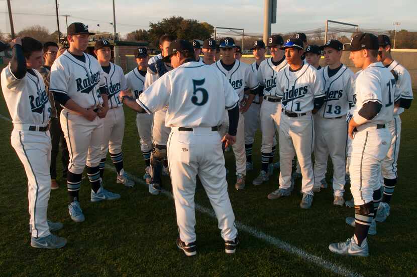 L.D. Bell baseball coach Paul Gibson, center,  talks to his team before they take on...