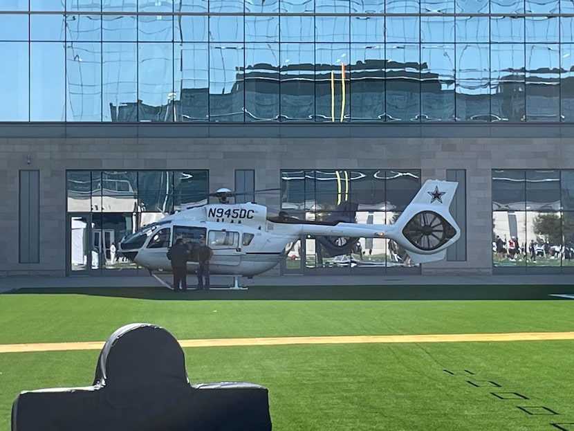 A helicopter carrying Dallas Cowboys owner Jerry Jones lands on one of the fields during...