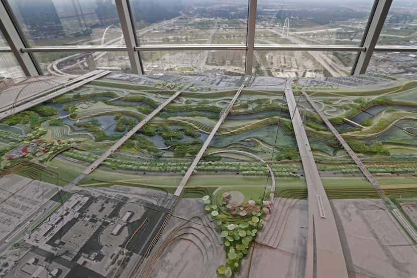 A model of the Trinity River Park plan sits in front of a view showing the Trinity River...