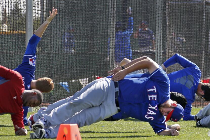Texas pitcher Cory Burns works on conditioning with teammates during Texas Rangers baseball...