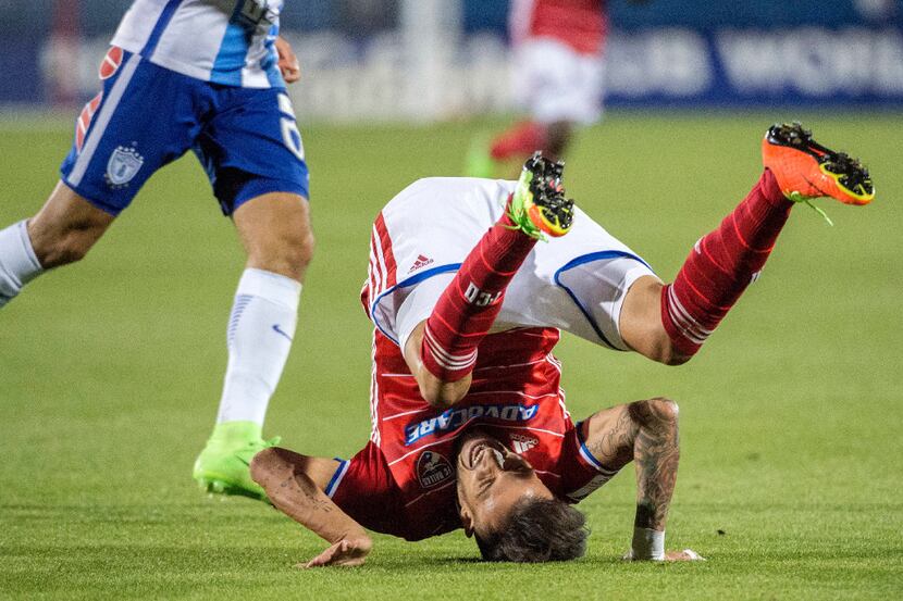 FC Dallas forward Maxi Urruti (37) tumbles after missing a pass during the second half...
