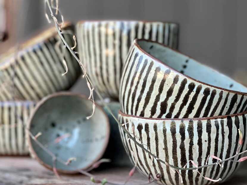 Handmaid ceramic bowls are covered in black and white stripes.