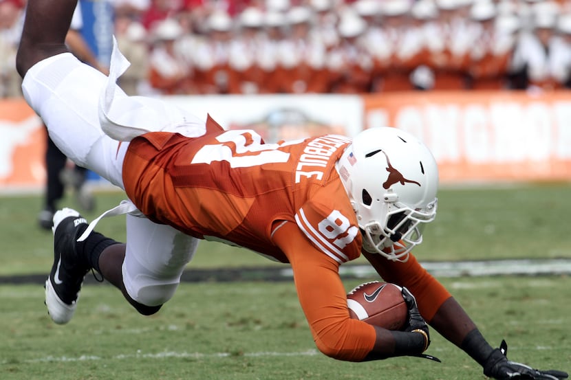 Texas Longhorns receiver Miles Onyegbule (81) is tripped up for a loss when an end around...