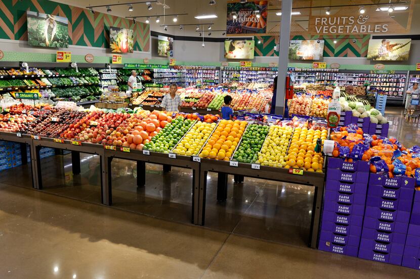 People browse the produce section at a Kroger Marketplace last month in Frisco.
