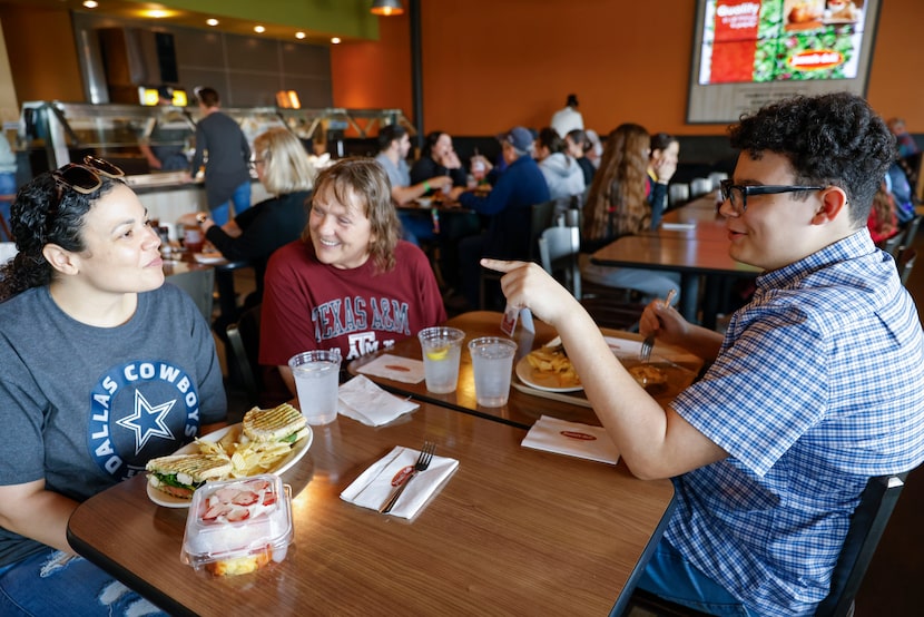 Tara Perry (left), mother Kandy and son Devin, 14, talk over breakfast after attending...