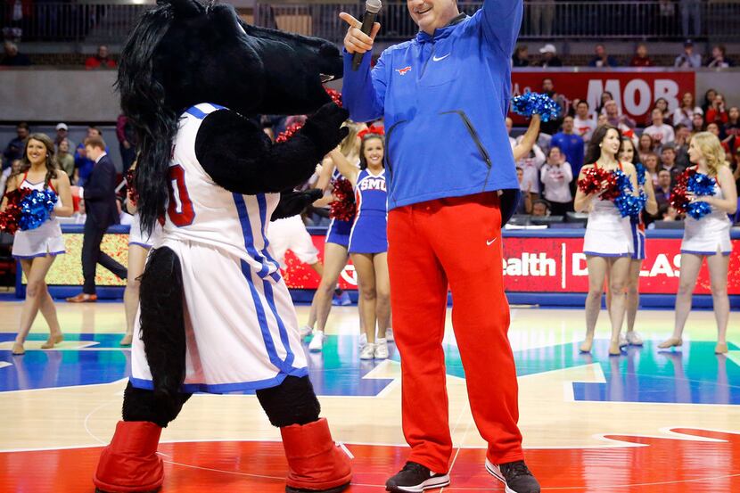 New Southern Methodist Mustangs head football coach Sonny Dykes speaks to the basketball...