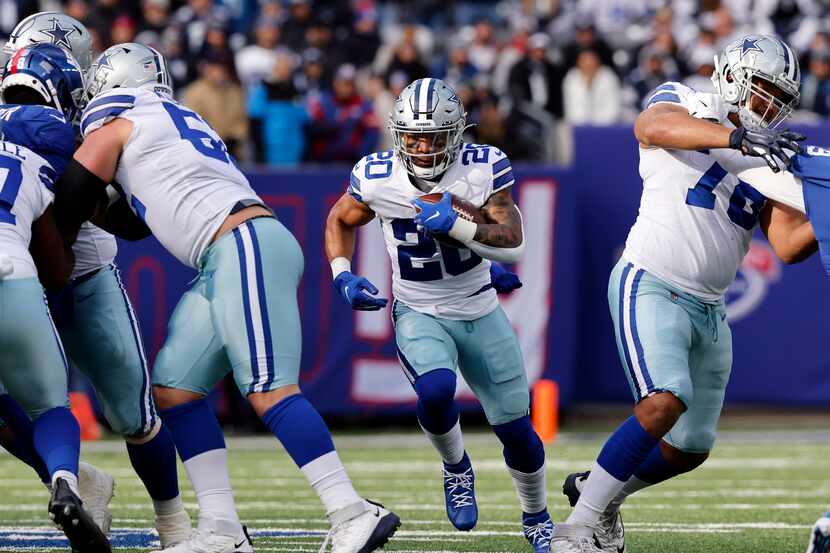 Dallas Cowboys running back Tony Pollard (20) carries the ball through a big hole in the...
