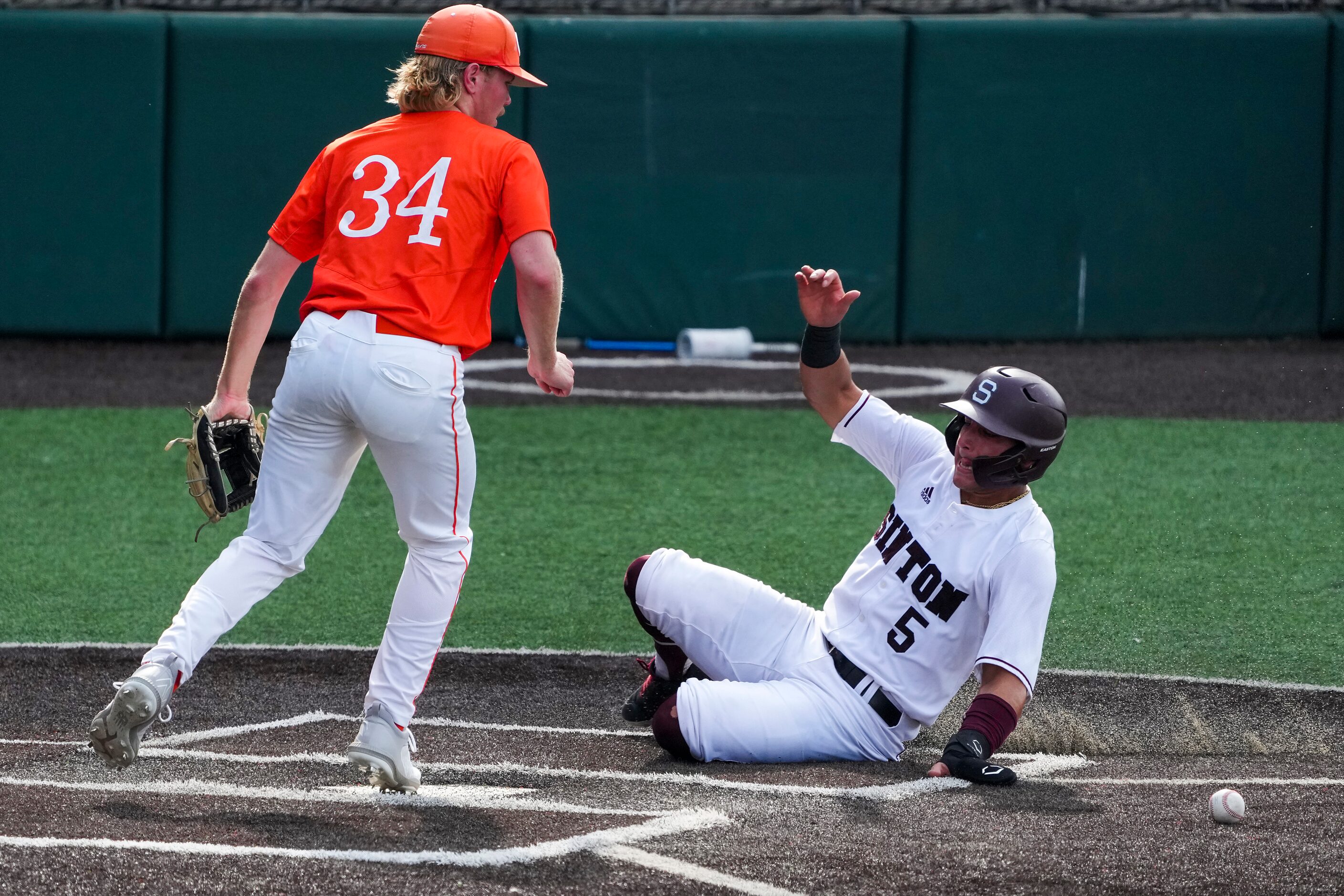 Sinton catcher Rylan Galvan (5) scores on a wild pitch past Celina pitcher Noah Bentley...