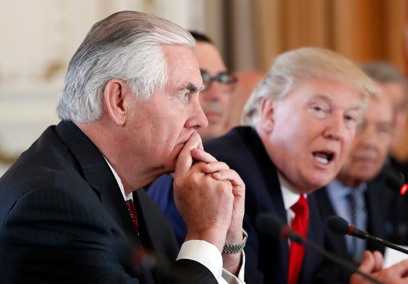 Secretary of State Rex Tillerson, left, listens as President Donald Trump speaks during a...