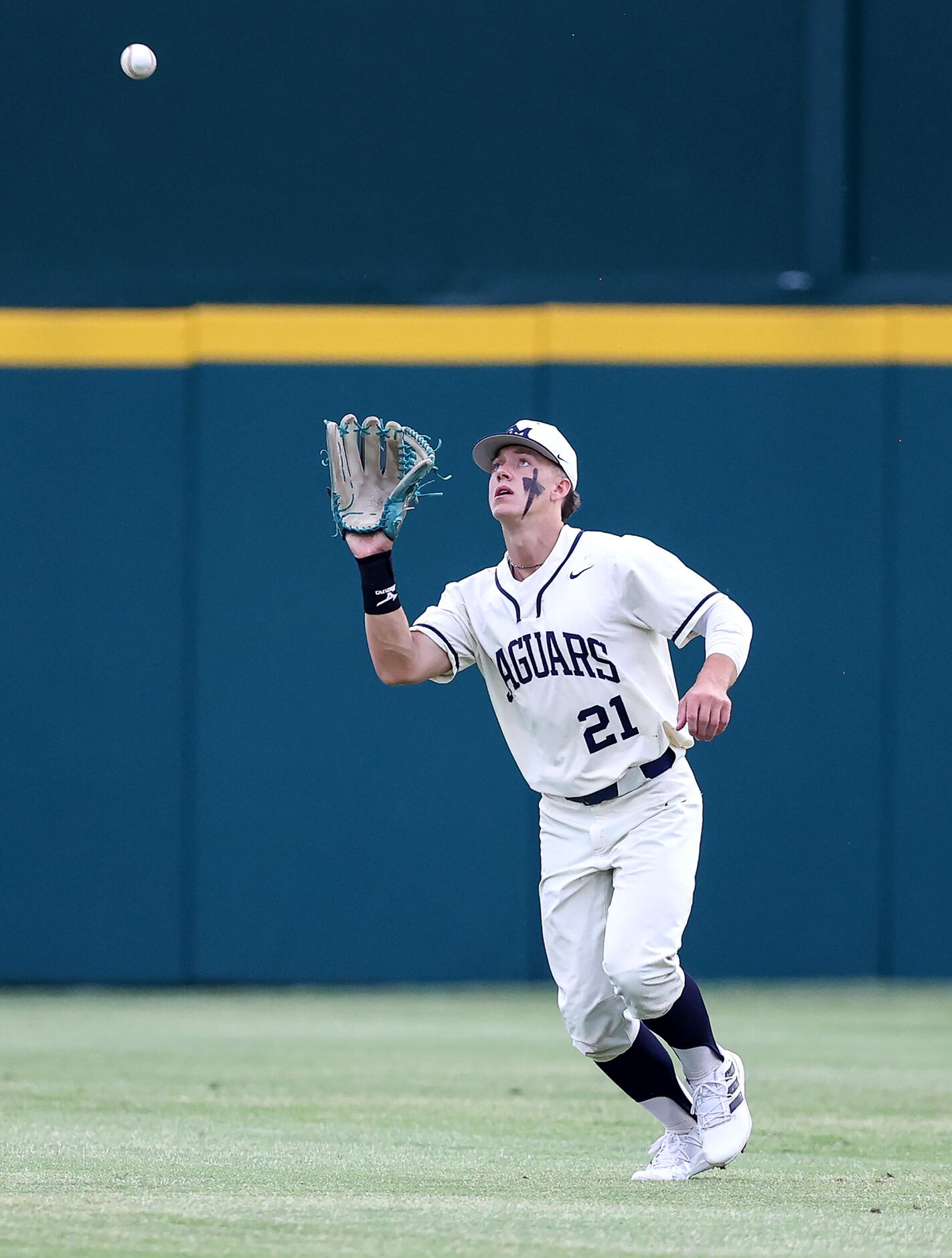 Flower Mound center fielder Sam Erickson comes up with an out against Denton Guyer during...