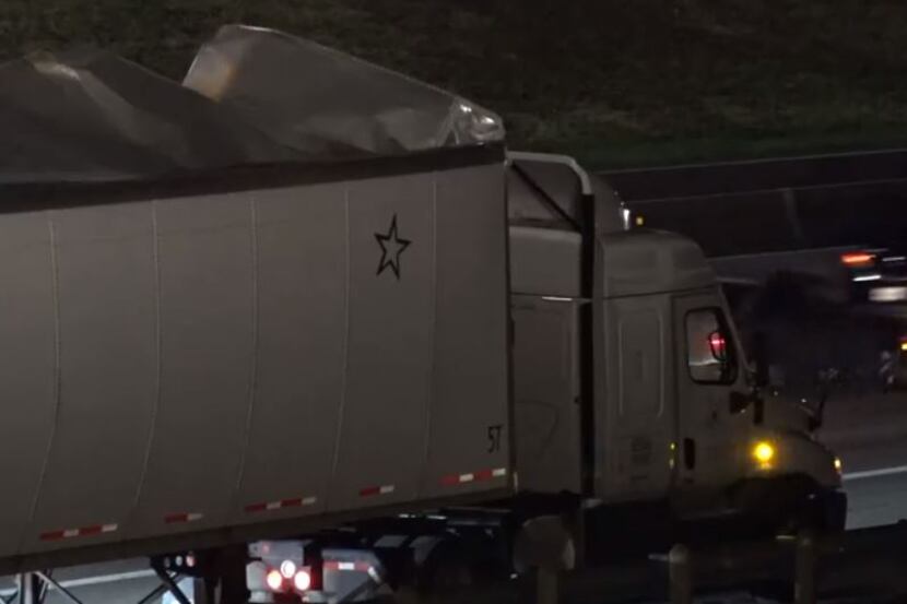 An 18-wheeler's trailer lies exposed after it burst open Wednesday morning in Euless. 