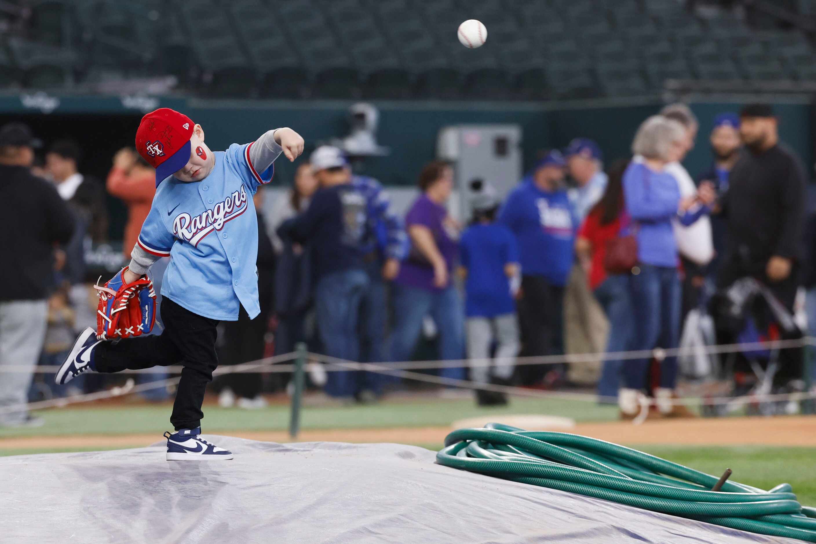 Cain Chandler, 3, throws a pitch from the pitcher’s mound during Texas Rangers Fan Fest on,...