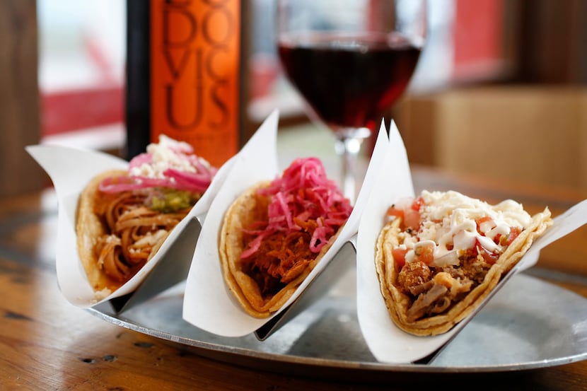 Tacos (from left) chicken tinga, chochinita pibil and crispy pork carnitas paired with...