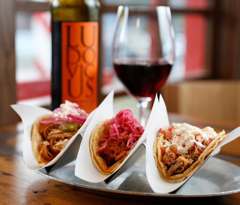 Tacos (from left) chicken tinga, chochinita pibil and crispy pork carnitas paired with...