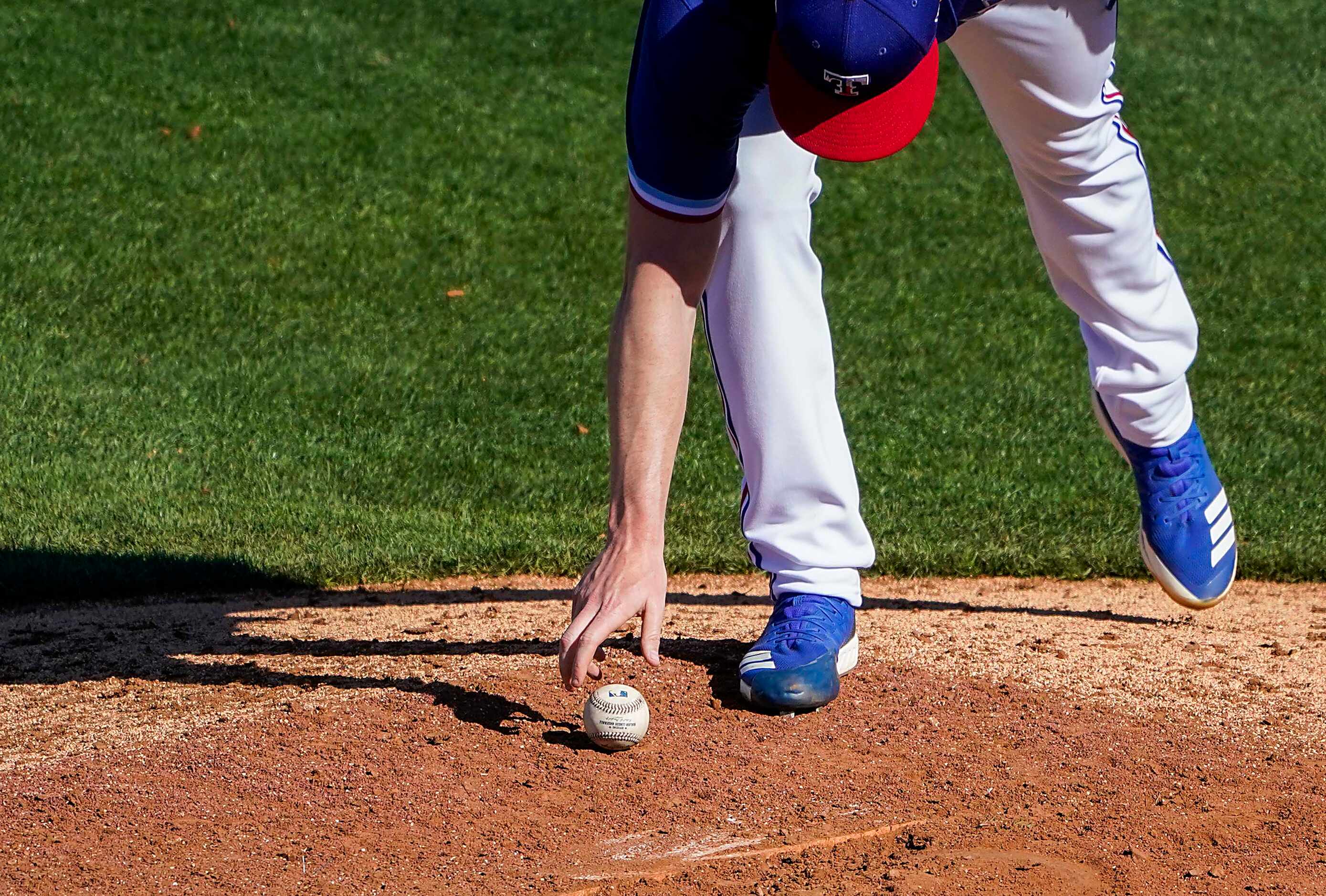 Texas Rangers pitcher Josh Sborz reaches for the ball as he comes in to pitch during the...