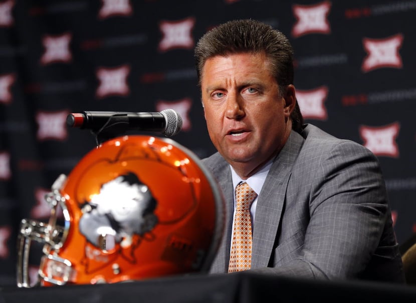 Oklahoma State head football coach Mike Gundy responds to questions from the media during...