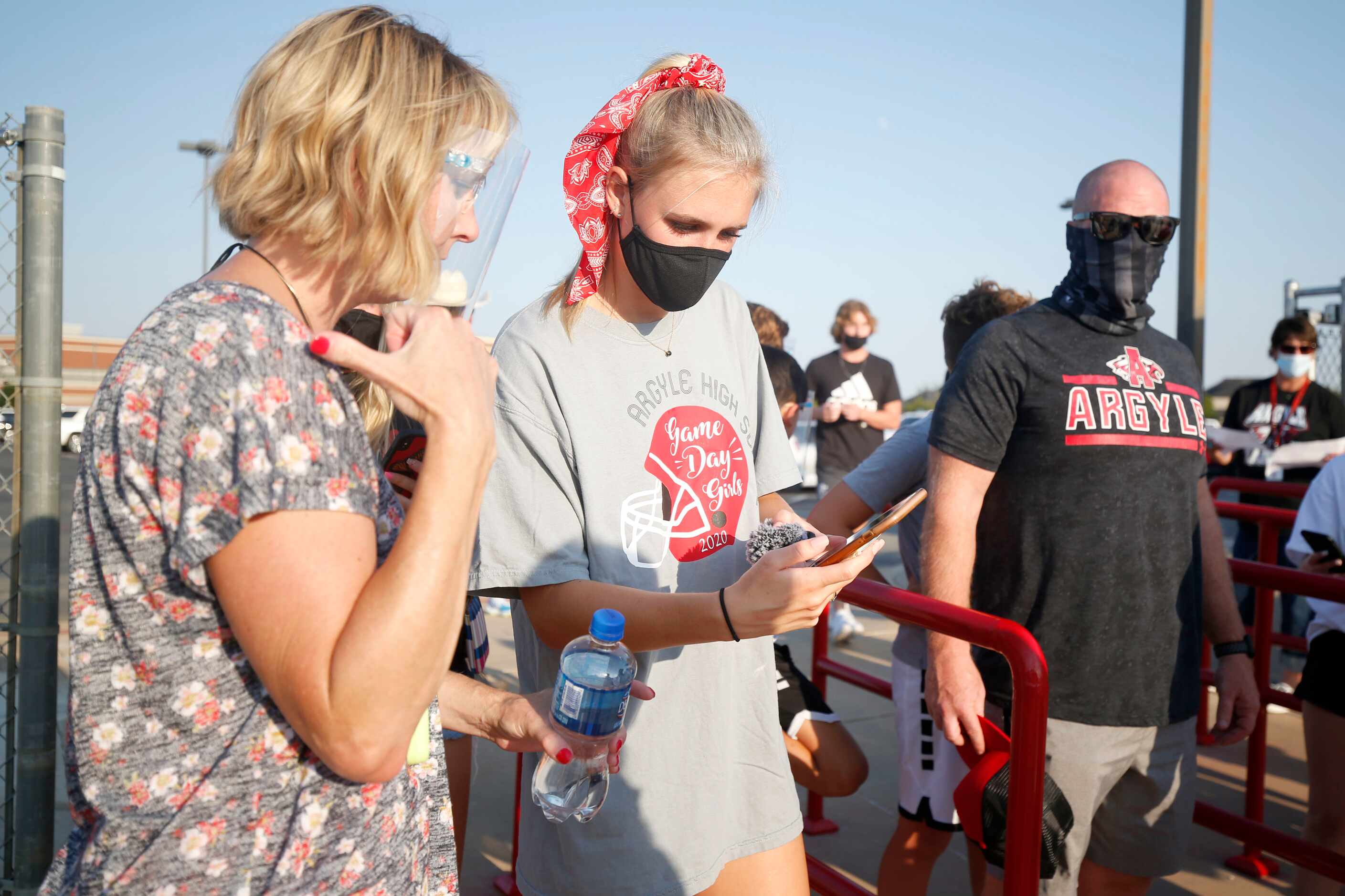 Argyle High School aid Jessica Pope helps Senior Kaelyn Reed, center, with her ticket prior...