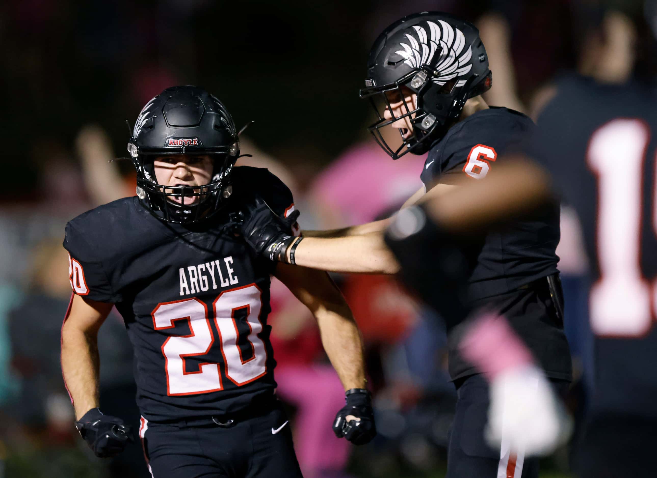 Argyle’s Landon Farris (20) and Lane Stewart (6) are fired up as they come up with a big...