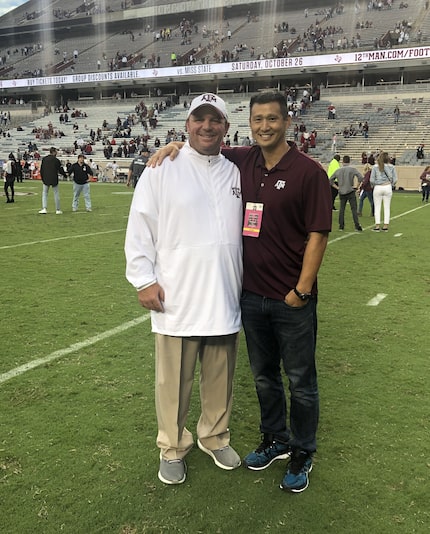 Texas A&M head coach Mike Elko (left) poses for a photo with Bruce Shang. Shang was a high...