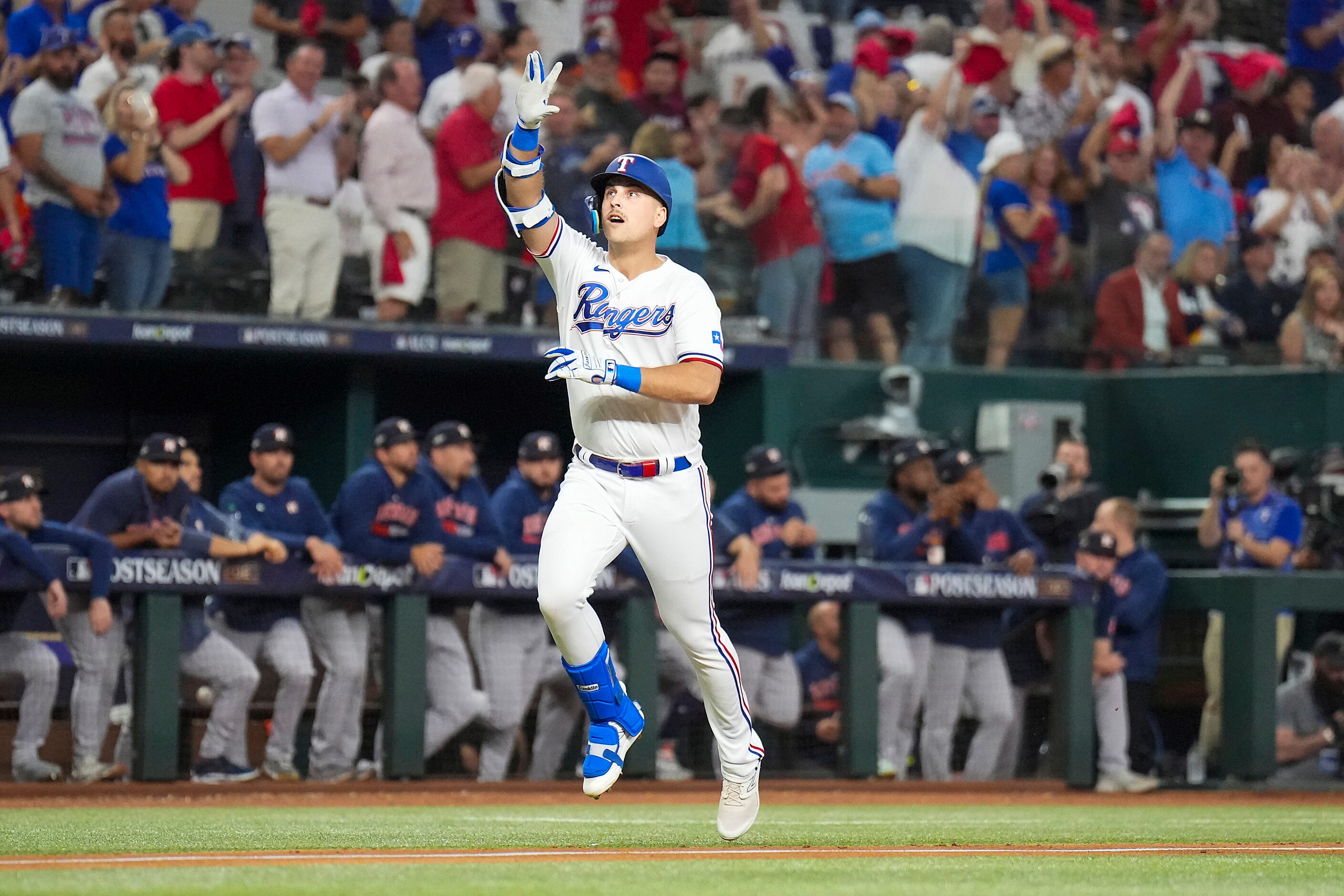 Texas Rangers first baseman Nathaniel Lowe celebrates as he rounds the bases after hitting a...