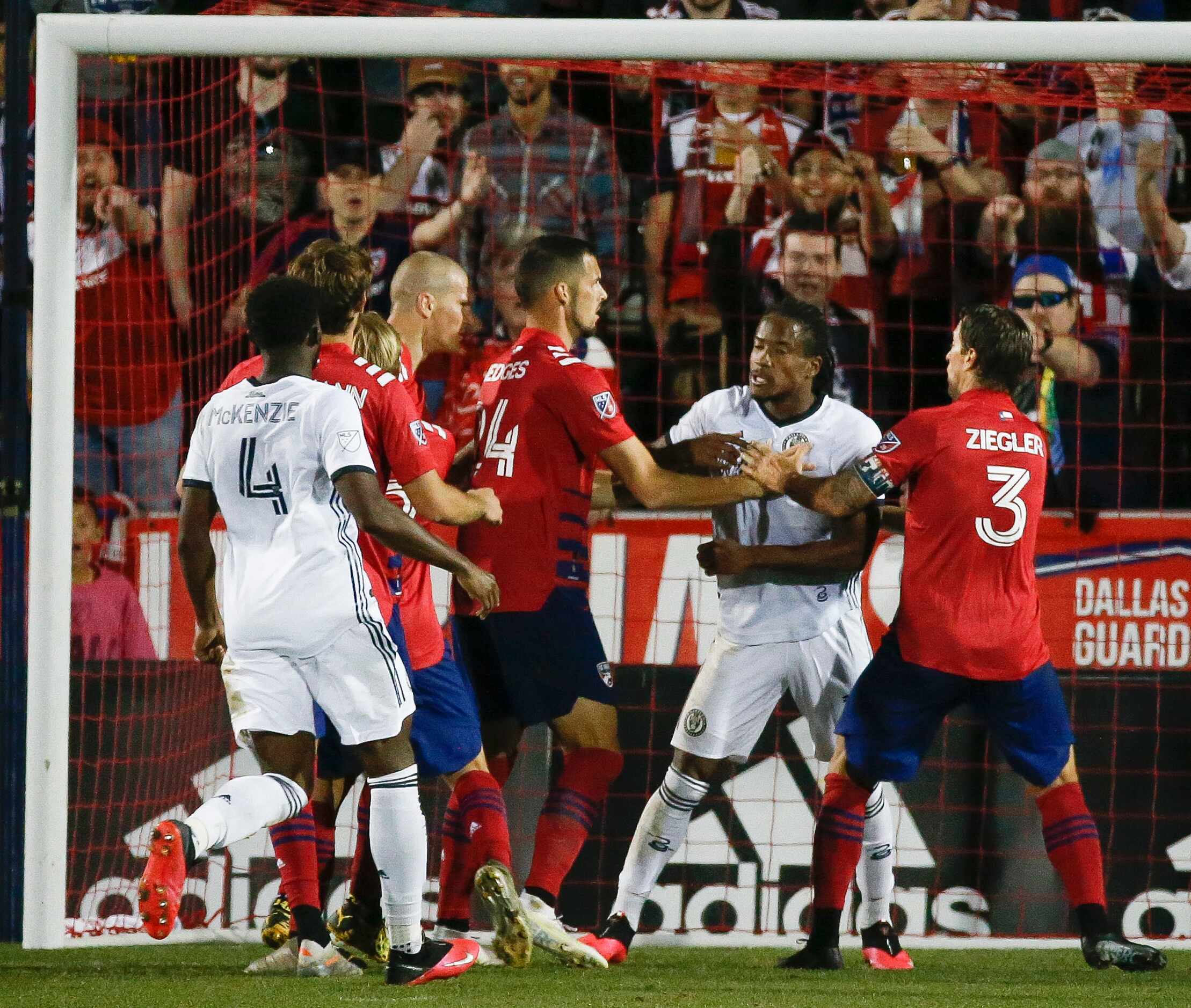 Philadelphia Union attacker Sergio Santos (17) clashes with FC Dallas players briefly during...