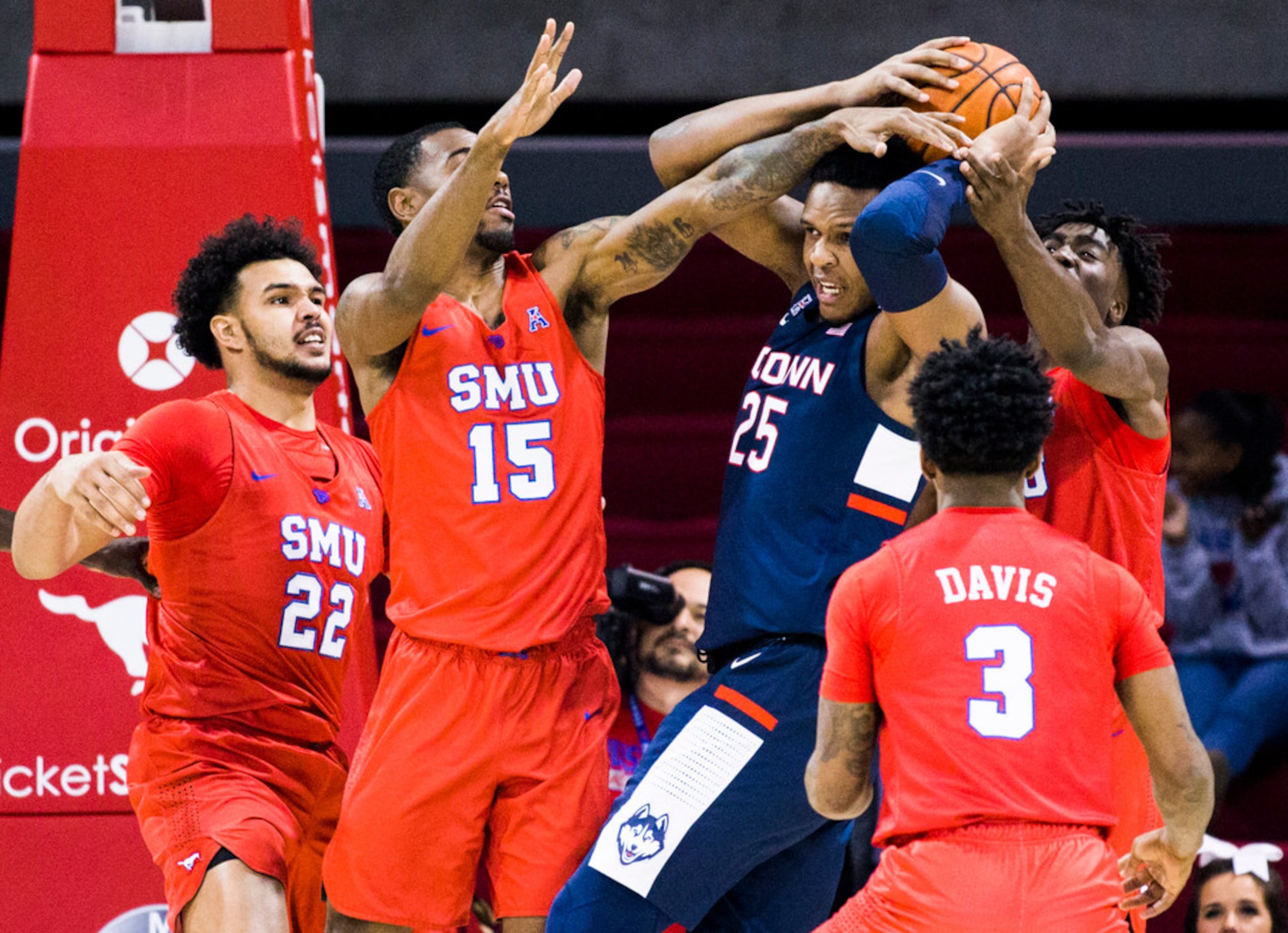 SMU players defend against Connecticut center Josh Carlton (25) during the first half of an...