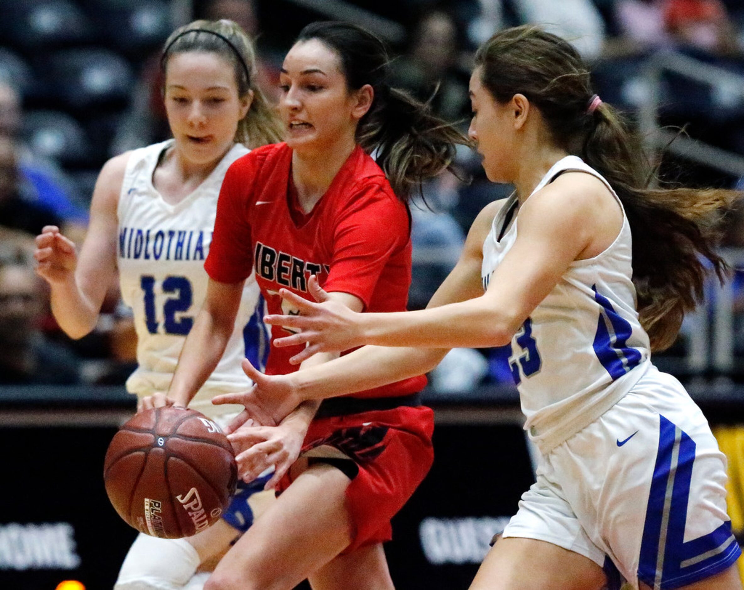 Frisco Liberty High School guard Maya Jain (24) loses the ball between Midlothian High...