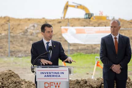 Sean Donohue (right), CEO at DFW International Airport, listens as Pete Buttigieg, U.S....
