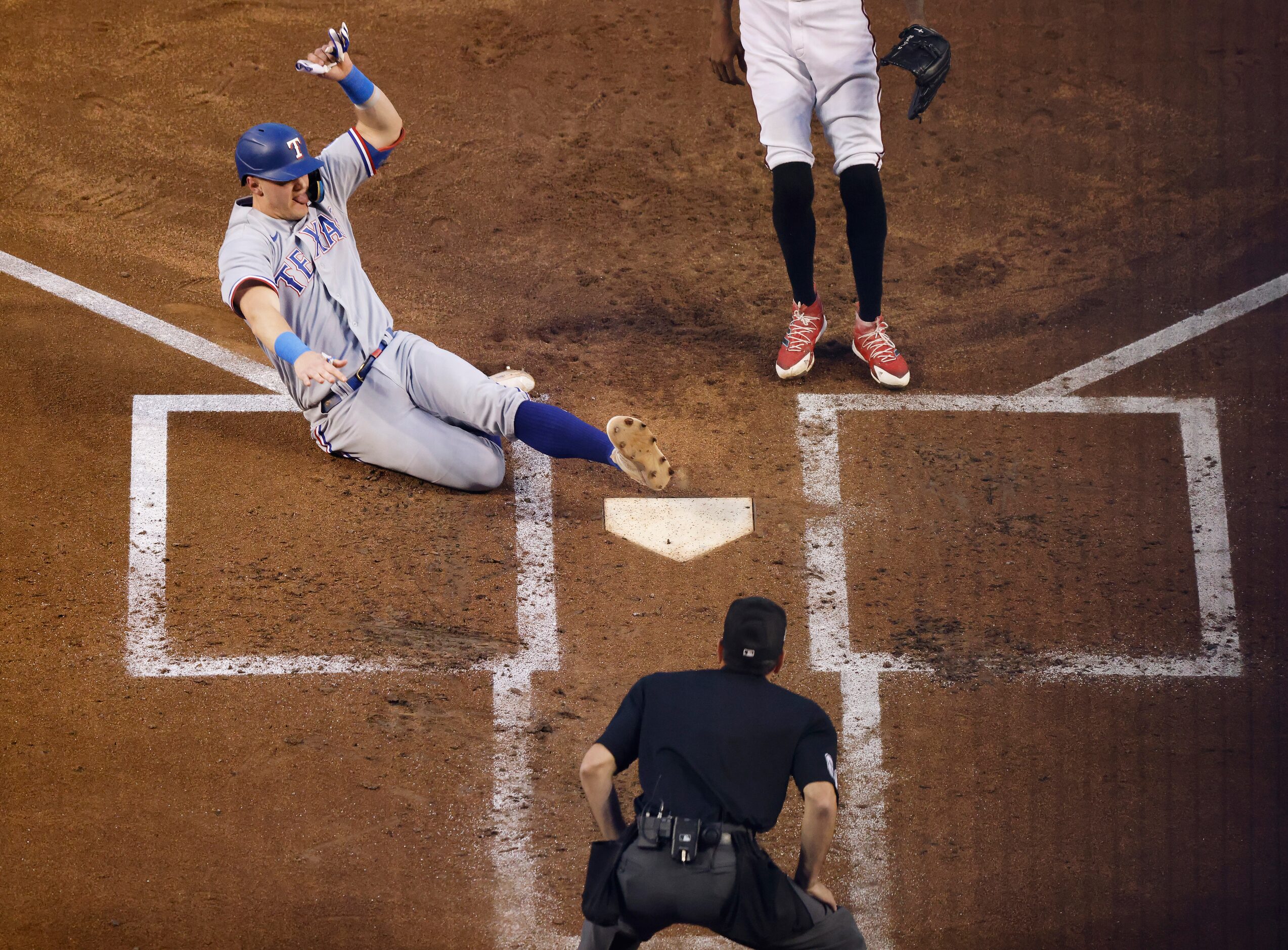 Texas Rangers’ Josh Jung scores on a wild pitch by Arizona Diamondbacks pitcher Miguel...