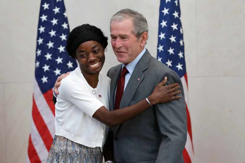 Former President George W. Bush, right, poses for a photo with Mondell Bernadette Avril...