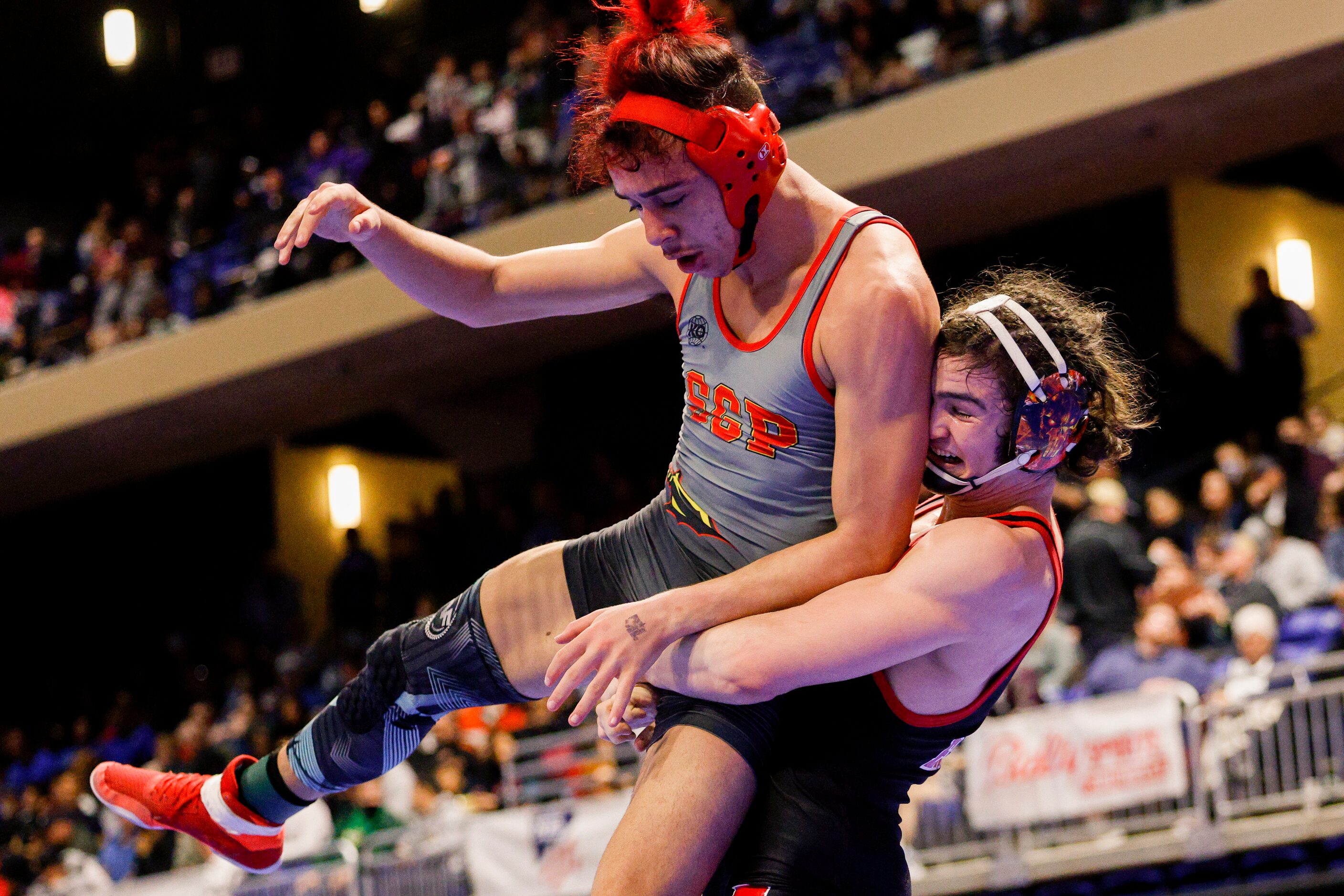 Mario Danzi of Allen (right) lifts Jesse Jennings of South Grand Prairie during a...