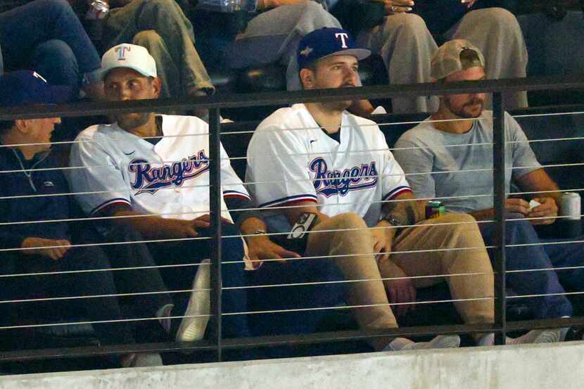 Former Dallas Mavericks player and basketball hall of famer Dirk Nowitzki (center left) sits...