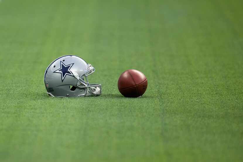 Detail shot of a Dallas Cowboys helmet and a ball seen before an NFL preseason football game...