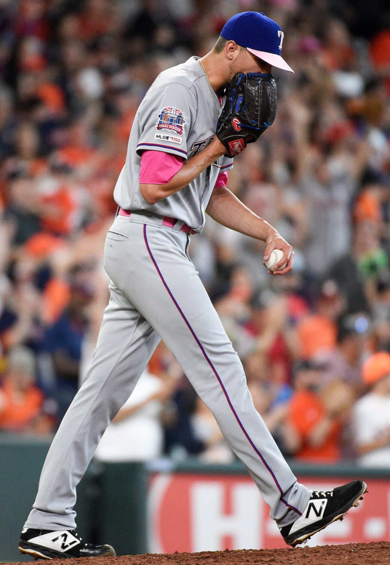 Texas Rangers relief pitcher Chris Martin yells into his glove after giving up a two-run...