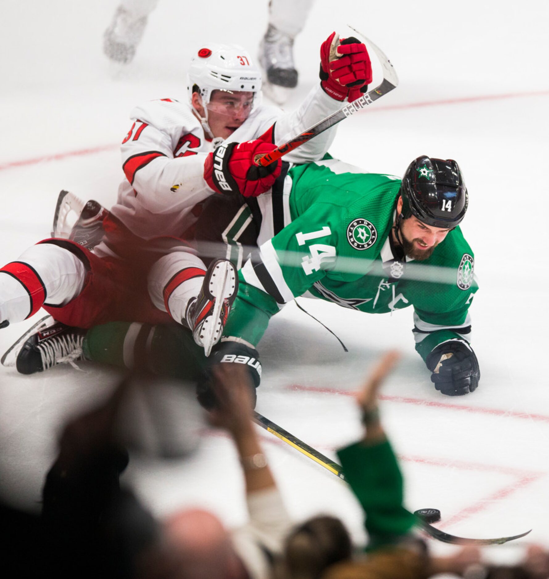 Dallas Stars left wing Jamie Benn (14) keeps control of the puck while defended by Carolina...