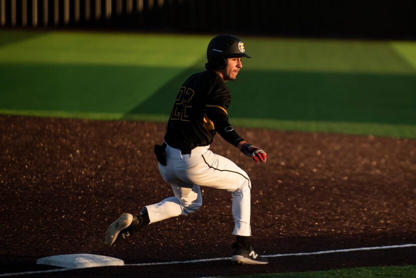 Forney second baseman Garret Hendricks (22) runs through first base during a baseball game...