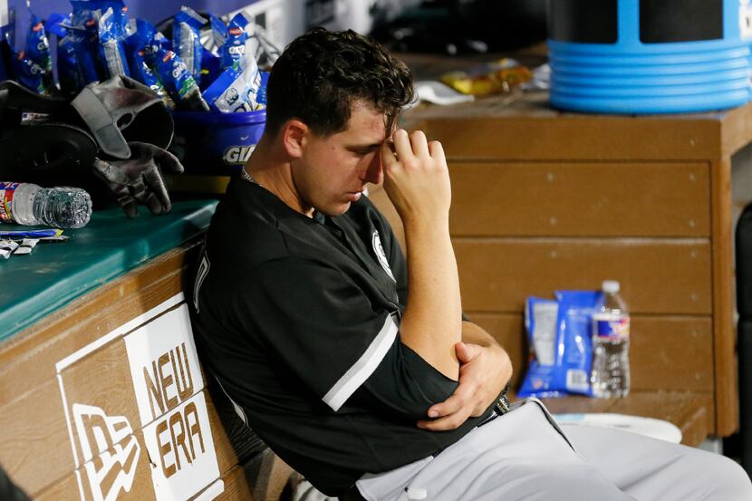 Chicago White Sox starting pitcher Derek Holland watches from the bench after being pulled...
