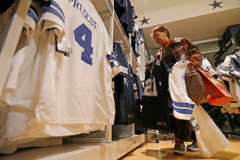 Customer Teresita Potts shops for jerseys of Dallas Cowboys quarterback Dak Prescott and...
